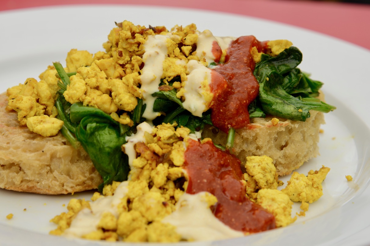 Seriously good tofu scramble on toast with hollandaise, spinach and salsa