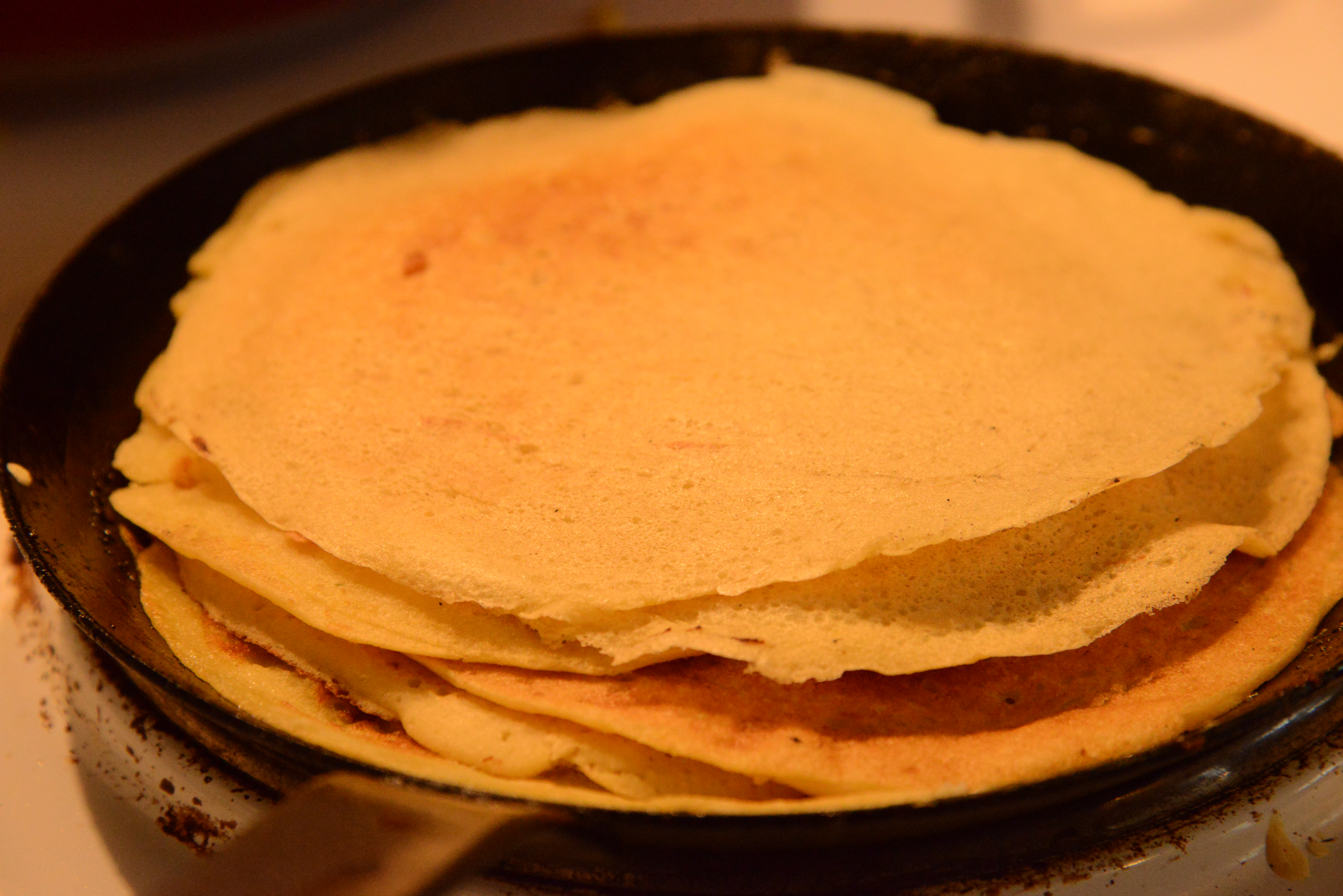 Stack of plant-based crêpes on a crêpe pan