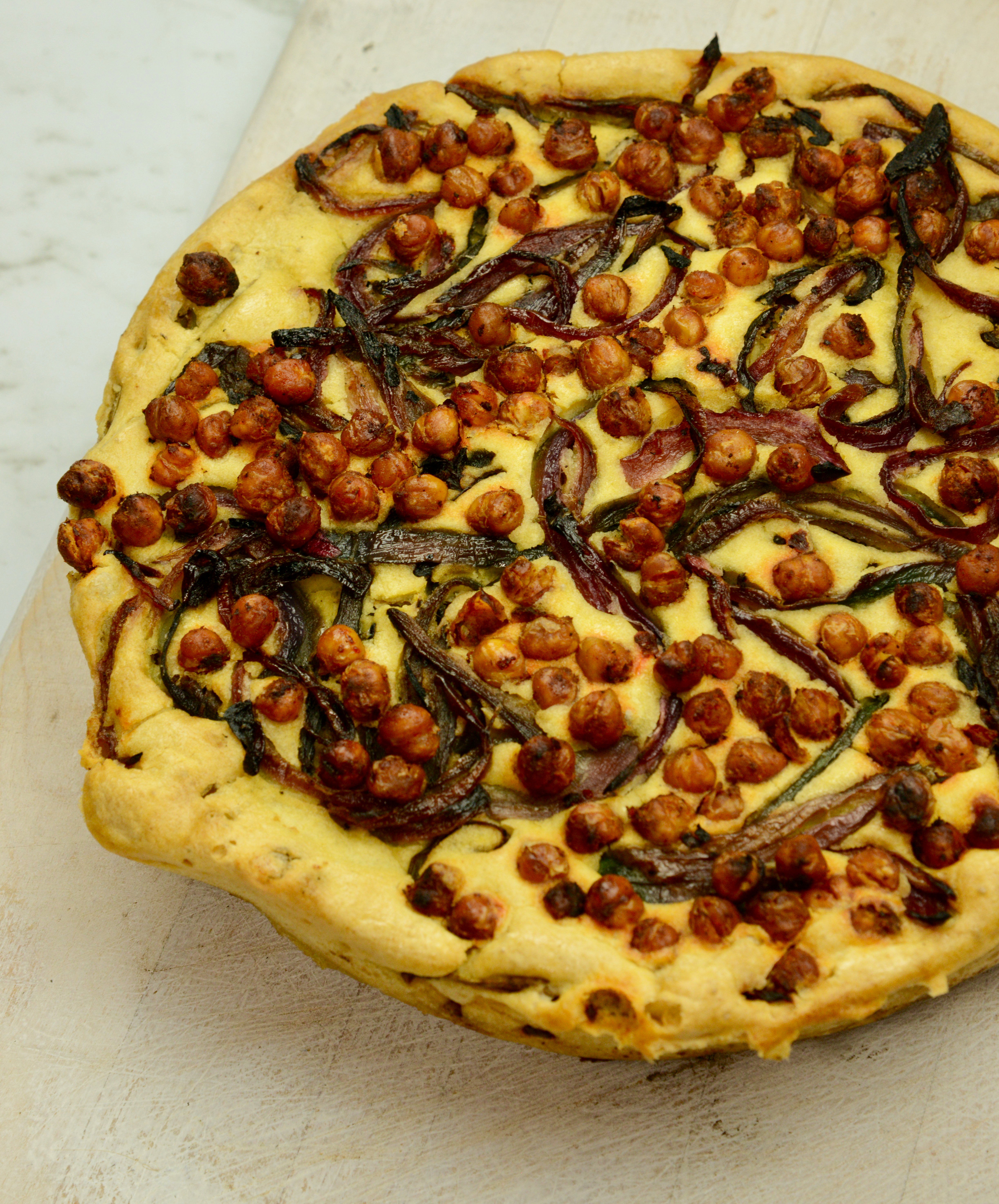 A plant-based kudu topped with roasted chickpeas and caramelised red onions