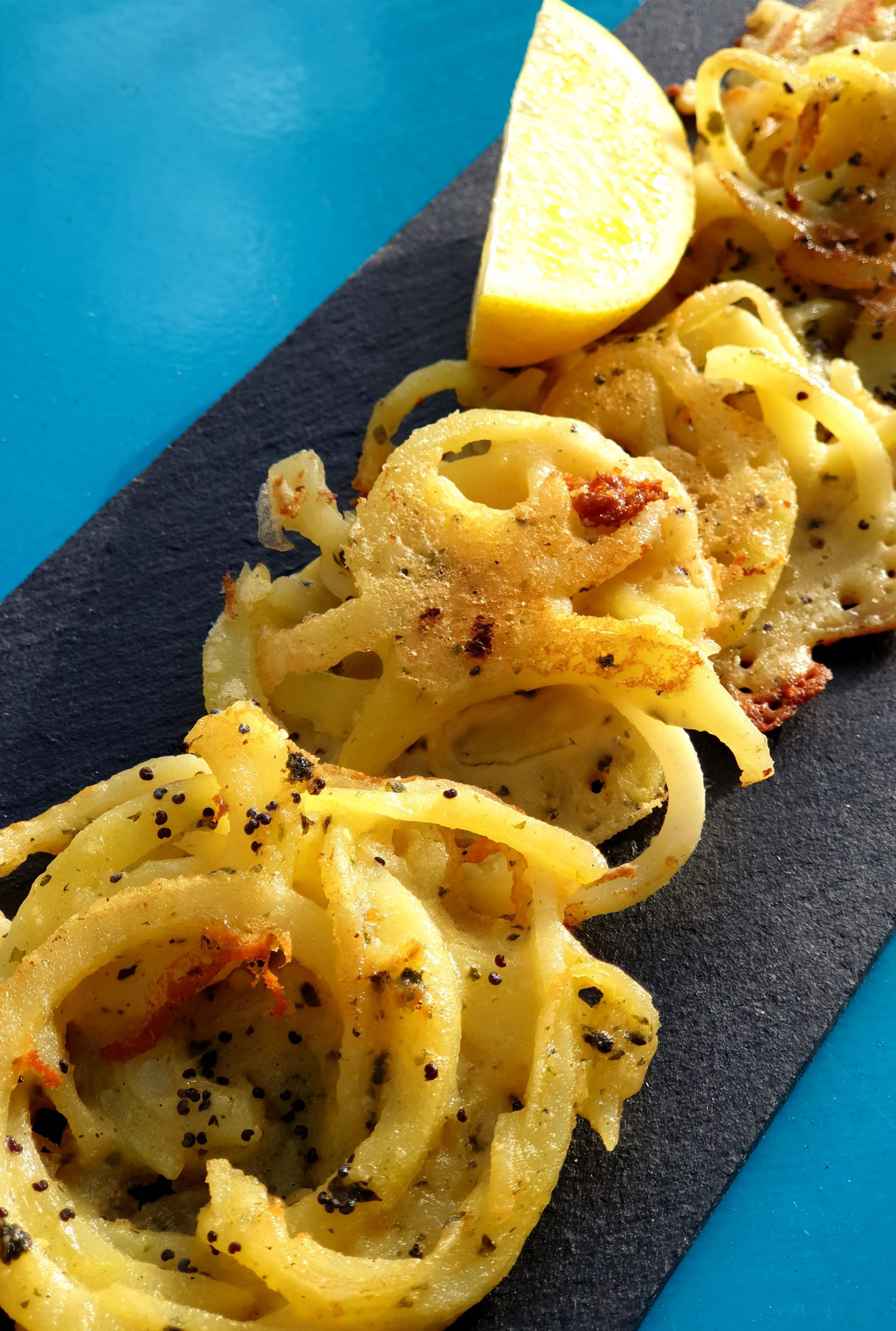 Slate of mock whitebait fritters with a wedge of lemon