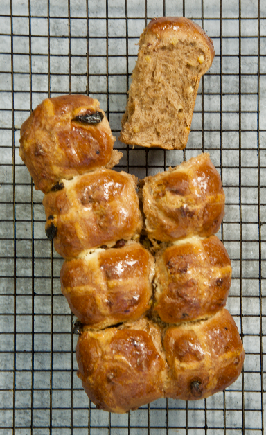 Loaf of Hot Cross Brioche on a cake rack
