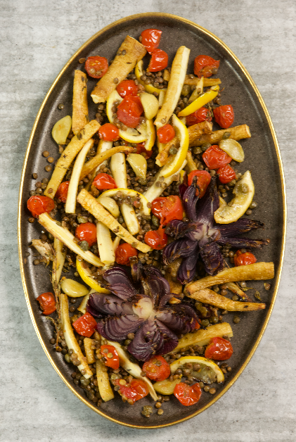 Gilt ended platter with roasted red onion flowers and parsnips, lentils, cherry tomatoes, lemon and garlic cloves