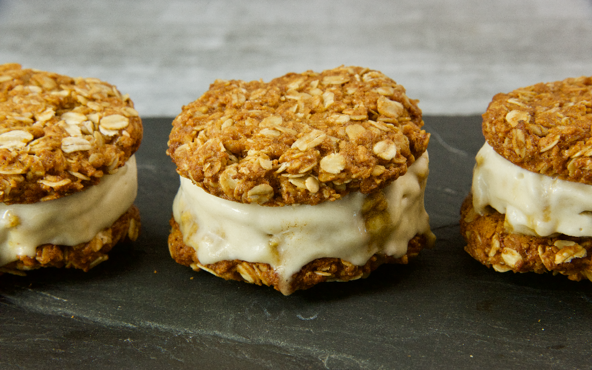 A trio of Hokey Pokey Anzac Creams on a dark slate