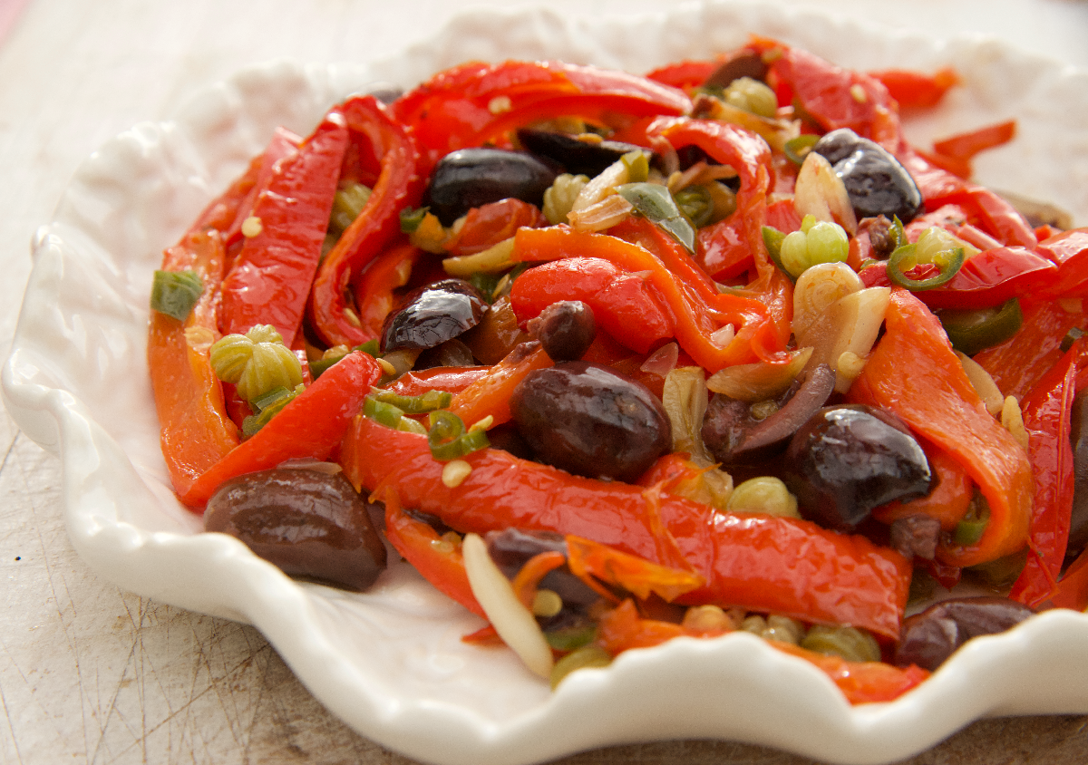 Nasturtium Caper, Olive and Chilli Peperonata on a white cabbage leaf plate