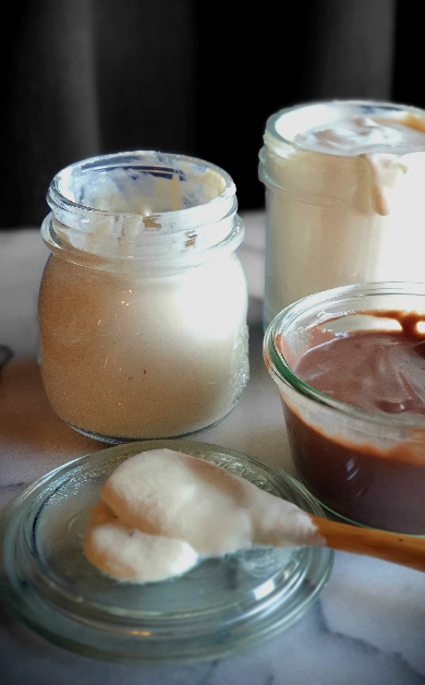 Plant-based Yoghurts, coconut, cashew and chocolate on a marble bench