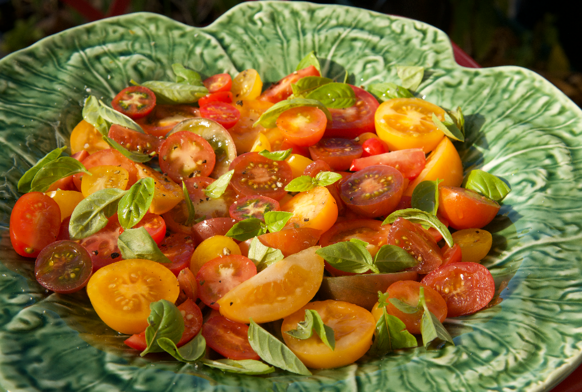 Cabbage ceramic dish with a salad of heritage tomatoes and basil