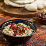 Moutabel, mutable or moutabbal, sprinkled with pomegranate seeds served with fresh pitta bread