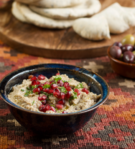 Moutabel, mutable or moutabbal, sprinkled with pomegranate seeds served with fresh pitta bread